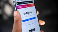 Persoon houdt gsm vast, op de gsm is Instagram geopend