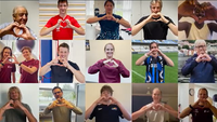 15 personen maken met hun handen een hartje
